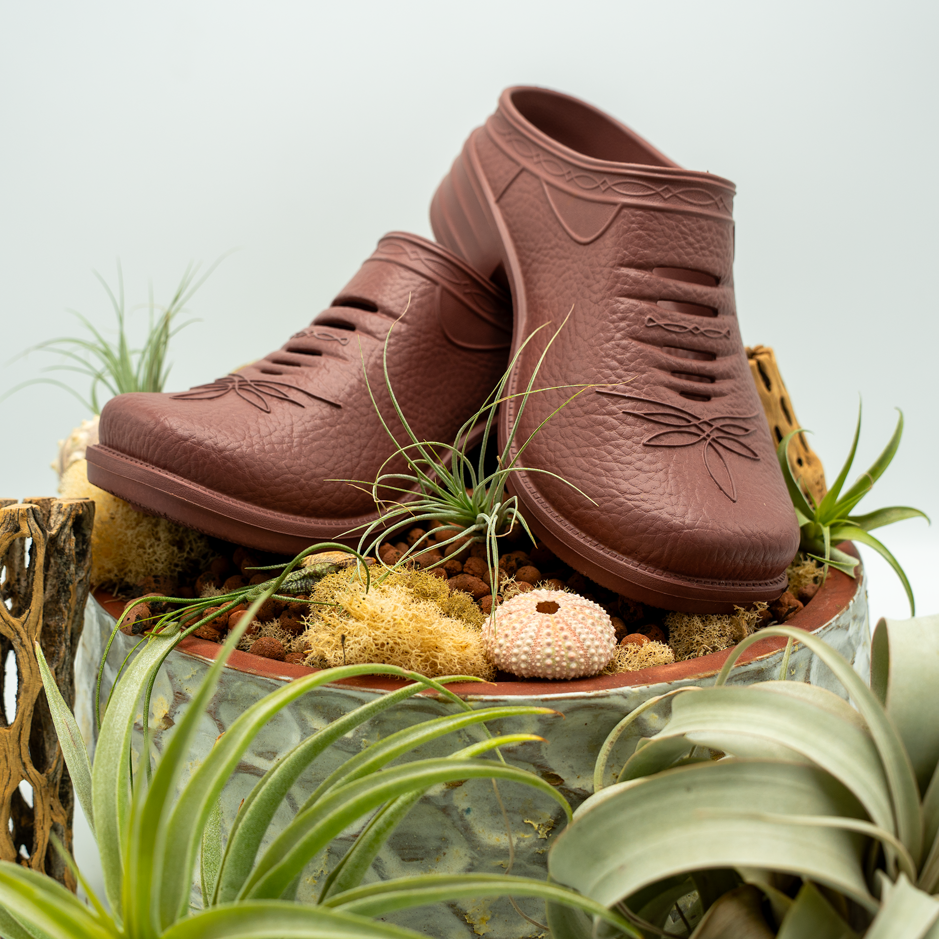 Pair of Westech Outrider slip-on shoes in Desert Rose on white background, plants, ultra-lightweight EVA Western shoes with supportive arch, Made in USA
