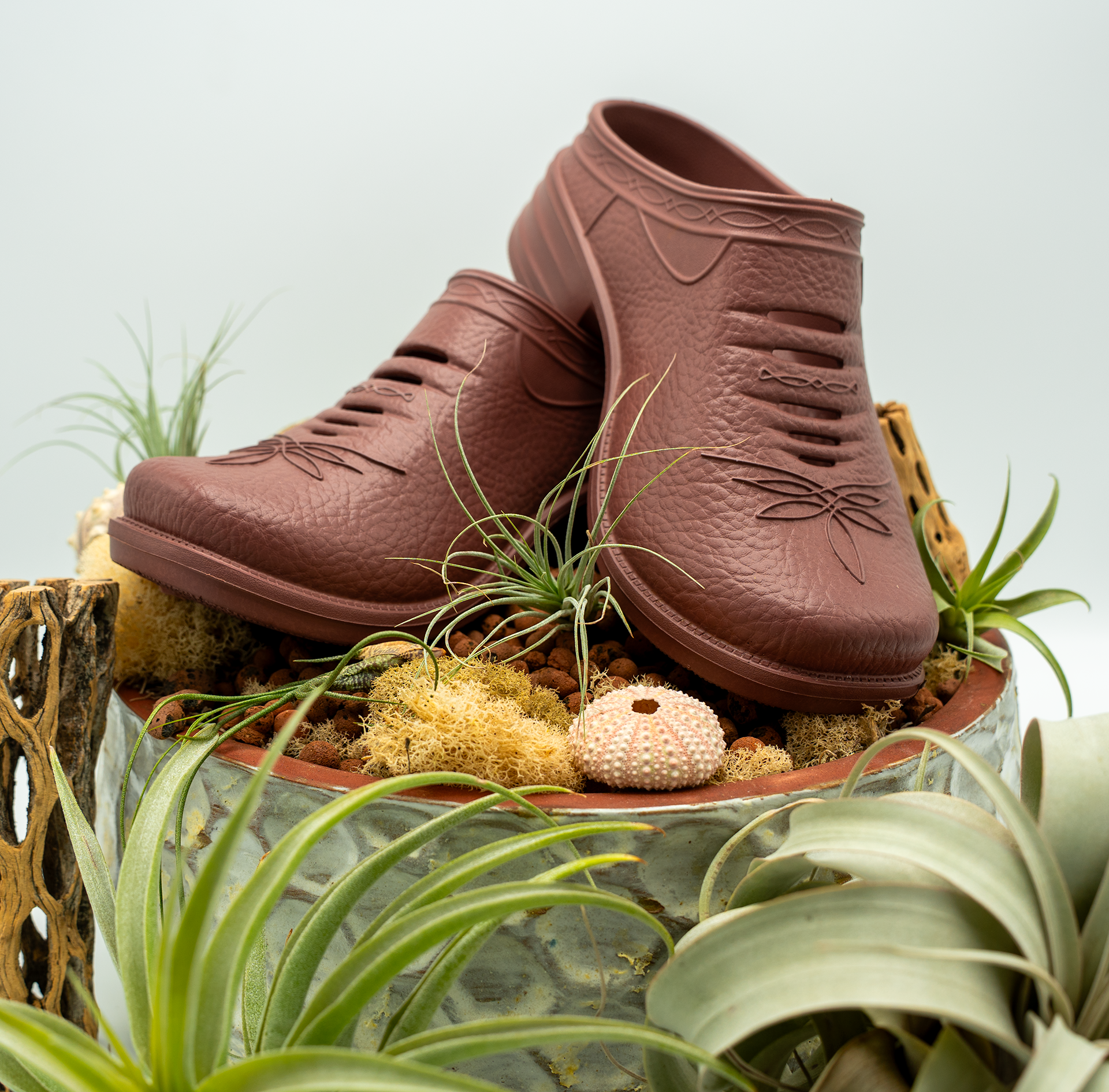 Pair of Westech Outrider slip-on shoes in Desert Rose on white background, plants, ultra-lightweight EVA Western shoes with supportive arch, Made in USA