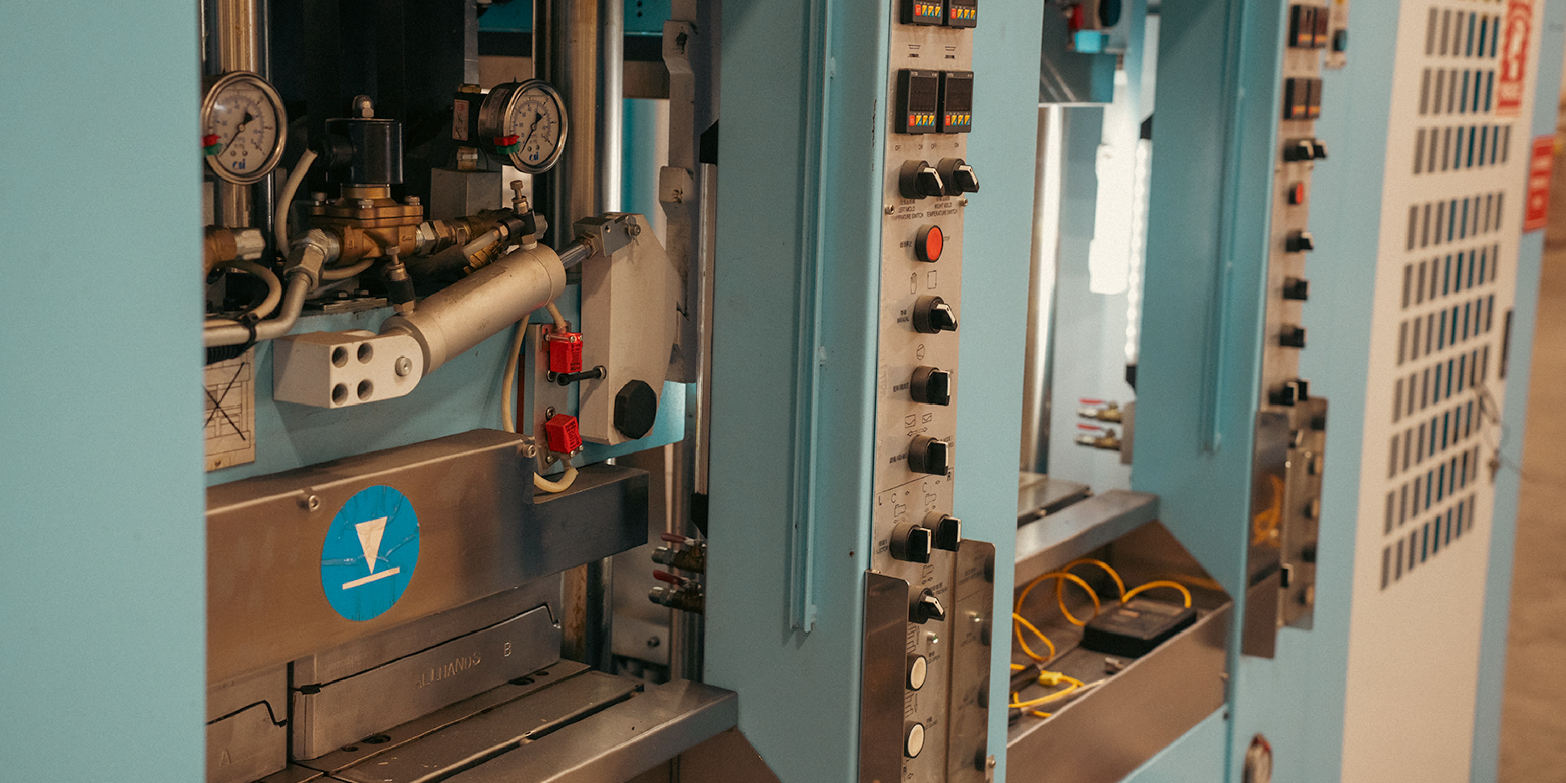 Industrial injection molding machine at Westech's factory, part of the American manufacturing process for Outrider slip-on shoes