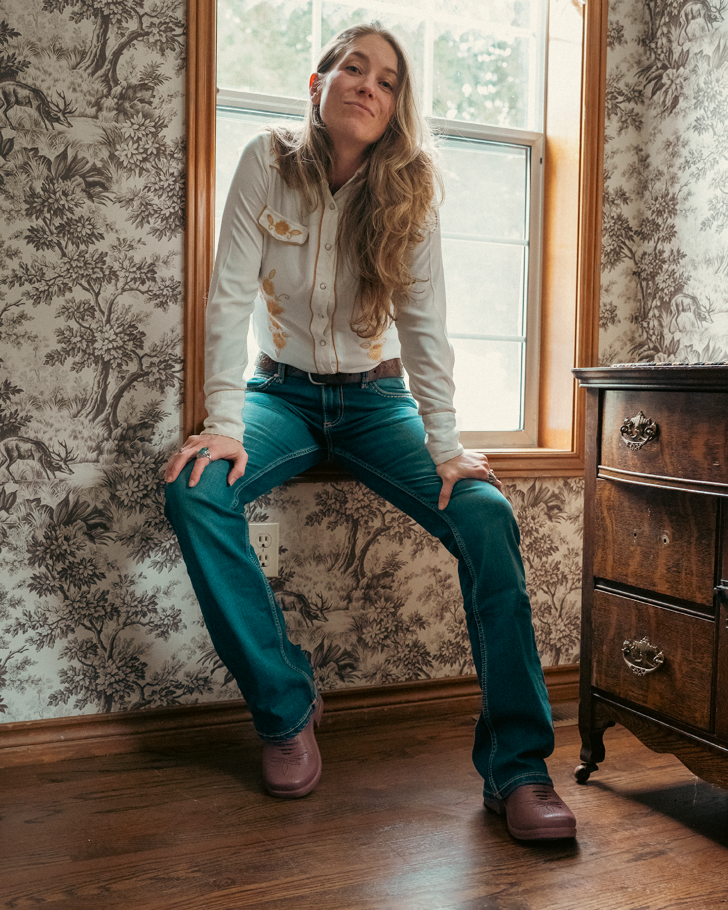 Woman wearing Westech Outrider slip-on shoes in a rustic Western home setting, showing the comfortable everyday style of our Made in USA footwear
