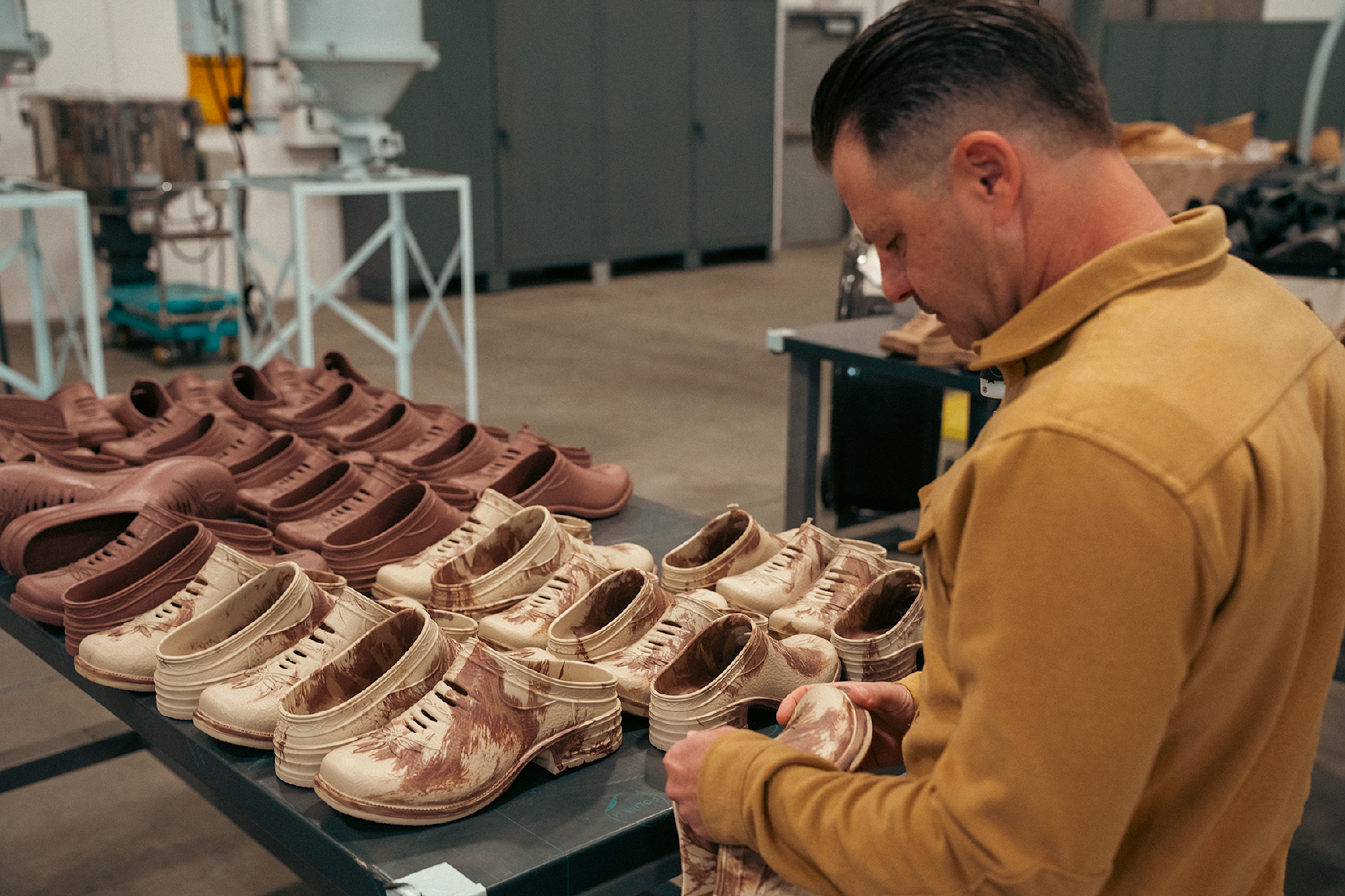 Westech team member quality-checking Outrider slip-on shoes in our Made in USA factory