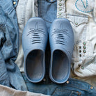 Westech Outrider slip-on shoes in Robin's Egg Blue styled on denim clothing, showing the vibrant blue color and Western details, lightweight comfort footwear made in the USA