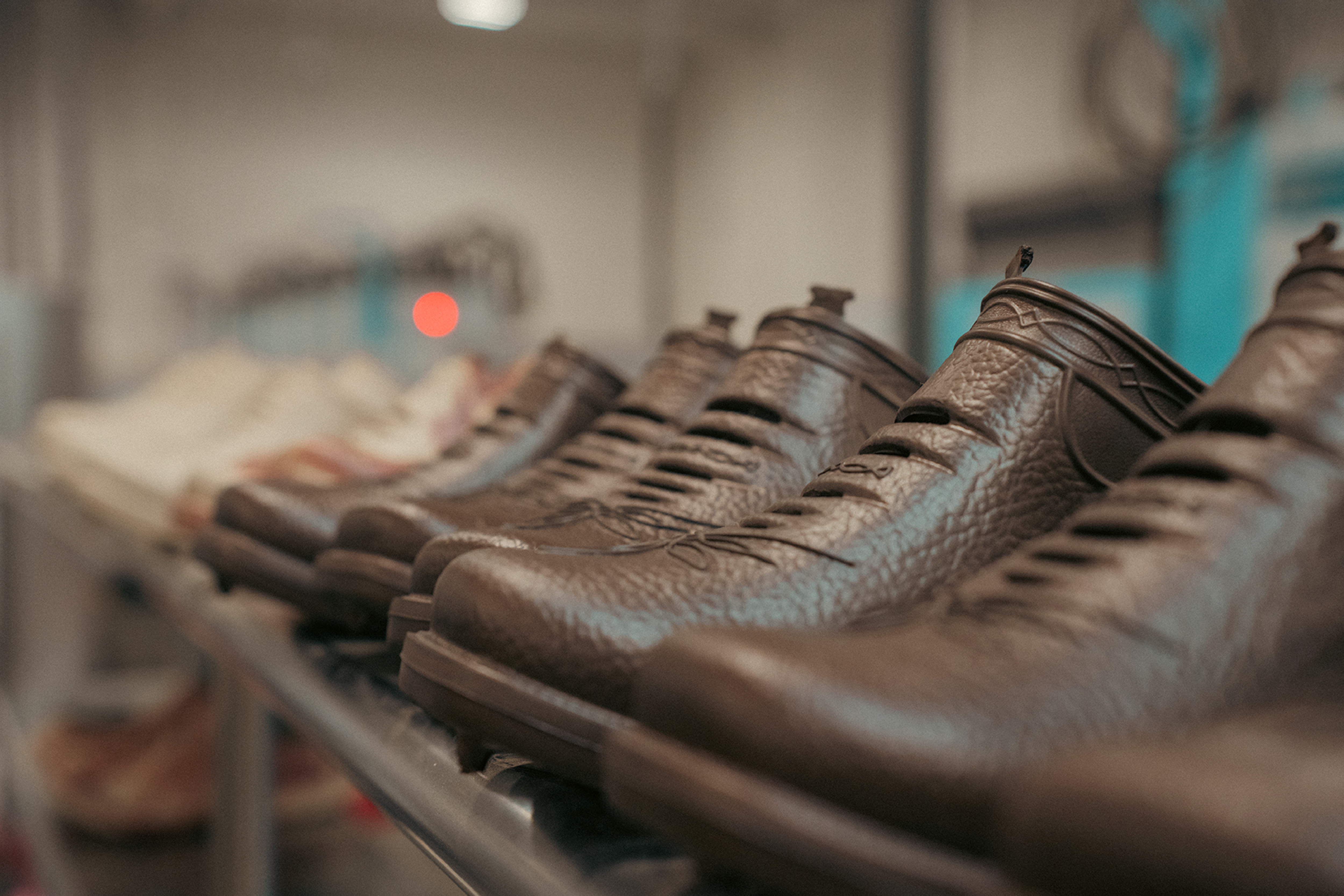 Row of Westech Outrider slip-on shoes in Barrel Brown lined up on a shelf, showcasing the Western design and quality craftsmanship of our Made in USA footwear