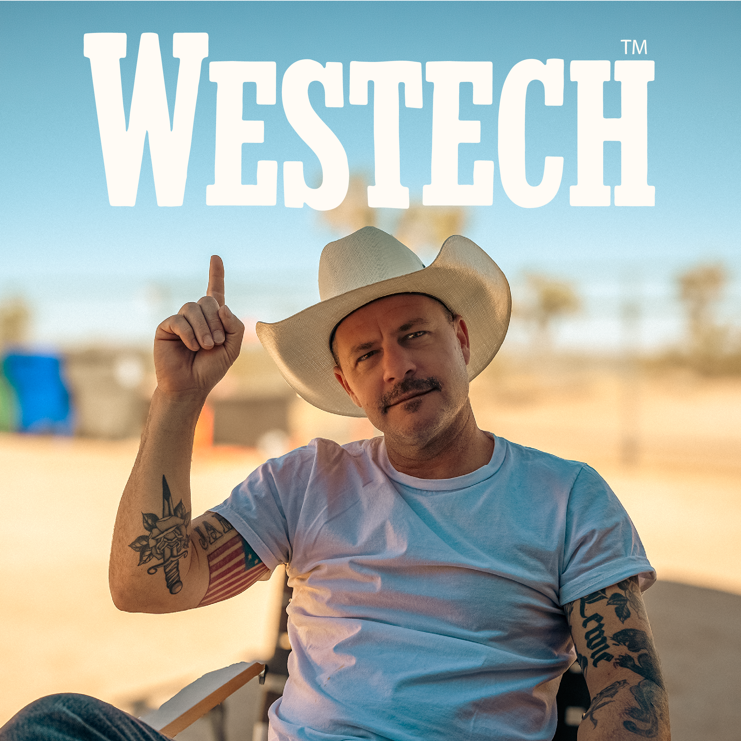 Man in cowboy hat wearing Westech t-shirt and pointing, representing the Western lifestyle and spirit behind Westech Outrider shoes, made in the USA